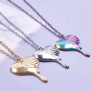 Detailed macro view of heart pendants in gold, silver, and iridescent lava fluid metal styles