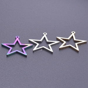 Macro view of three hollow star pendants in gold, silver, and iridescent steel finish