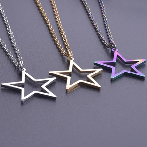 Macro shot of hollow pentagram pendants in silver, gold, and rainbow finishes