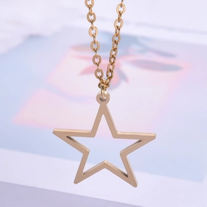 Macro detail of a 18k gold-plated stainless steel hollow star pendant on a fine chain