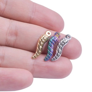 Macro shot of colorful 18K stainless steel chili pendants in gold and rainbow finishes