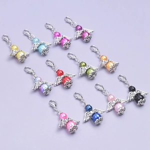 Close-up of colorful pearl angel wing charms with lobster clasps for party favors