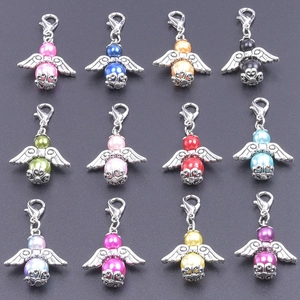 Detailed grid view of 12 colorful angel wing charms with lobster clasps and pearls