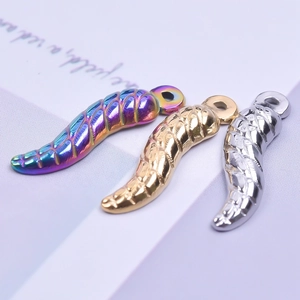 Detailed macro view of colorful, gold, and silver 18K stainless steel chili pendants