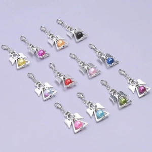 Detailed macro view of 12 colorful pearl angel wing charms with lobster clasps