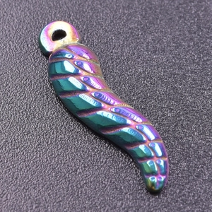 Macro shot of 18K stainless steel wing pendant with colorful iridescent plating details