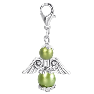 Detail of angel wing pendant with green pearls and vintage lobster clasp for gifts