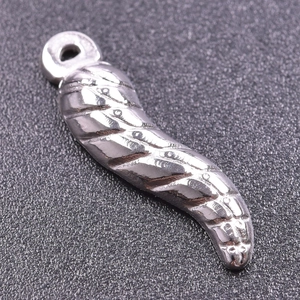 Macro shot of silver textured chili pepper pendant in stainless steel for DIY jewelry