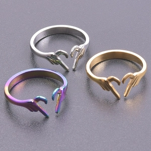 Three-piece set of heart gesture open rings in silver, gold, and rainbow stainless steel