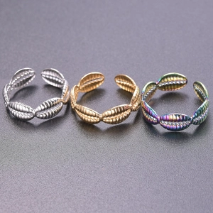 Three open adjustable seashell rings in gold, silver, and iridescent titanium steel