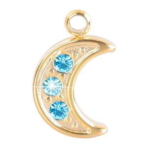Detail view of 18K gold moon pendant featuring three light blue crystals and top hanging ring