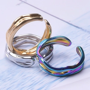Three-piece set of wave-shaped stainless steel open rings in gold, silver, and iridescent