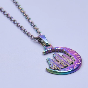 Detail of moon and tree pendant with rainbow aurora plating and O-chain linkage