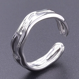 Macro detail of silver adjustable liquid lava textured ring in polished stainless steel