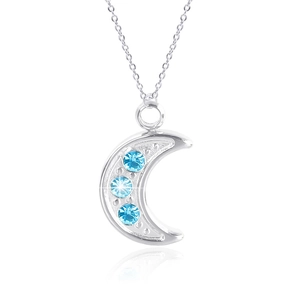 Close-up of silver crescent moon pendant with three blue crystals on a thin chain