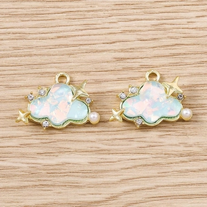 Detailed macro view of blue cloud pendant with rhinestones and pearl for DIY jewelry