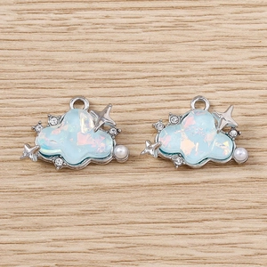 Detail showing two blue glitter cloud pendants with stars and pearls for DIY jewelry making