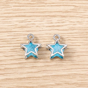Macro detail of blue crystal star pendants with silver metal frames for DIY jewelry