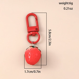 Detail view of 3D red strawberry keychain with dimensions 5.8cm height and 1.7cm width
