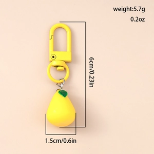 Detailed macro view showing yellow pear keychain dimensions 6cm x 1.5cm and 5.7g weight