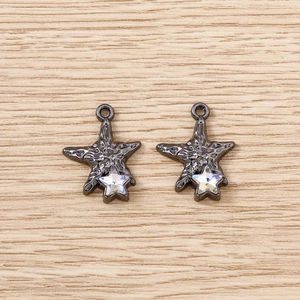 Detail of gunmetal starfish pendants with hammered texture and tiny crystal stars