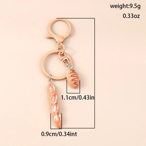 Detailed macro view of realistic baguette and pastry charms on a creative keychain ring