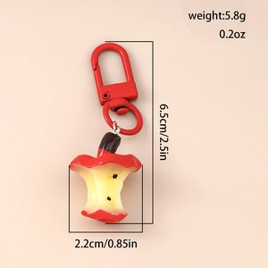 Detailed macro view of an apple core keychain pendant with red coating and 5.8g weight