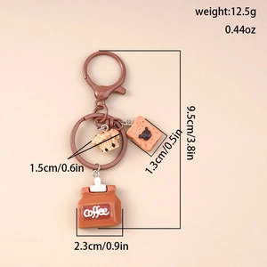 Detail view of coffee and dessert keychain showing 9.5cm length and 12.5g weight specs