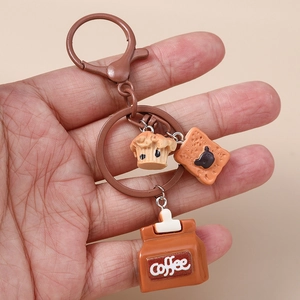 Coffee themed keychain with mini muffin, bear cookie, and coffee bag charms on a ring