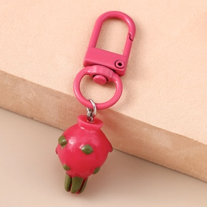 Close-up of a creative dragon fruit keychain with pink metal clip and resin pendant