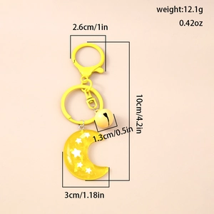 Detailed view of yellow resin moon keychain with star sequins and measuring dimensions