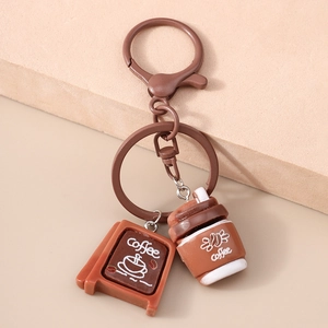 Macro detail of brown coffee house sign and take-away cup pendant on keychain