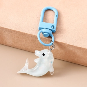 Détail d'un porte-clés dauphin avec remplissage irisé et crochet bleu clair mat