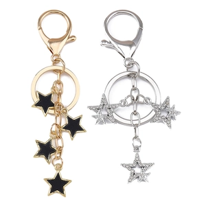 Porte-clés chic avec étoiles en émail doré et strass argentés avec fermoirs mousquetons