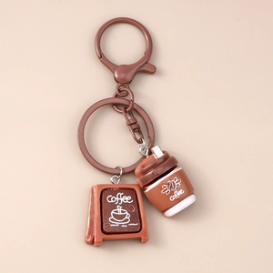 Macro shot of coffee cup and signboard pendants on a creative brown keychain