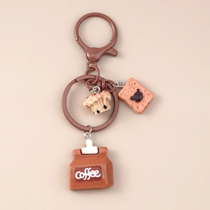 Detail of coffee keychain with muffin, toast, and brown coffee bag charms on metal ring
