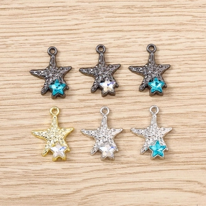 Detail showing starfish pendants with hammered metal texture and sparkling star rhinestones