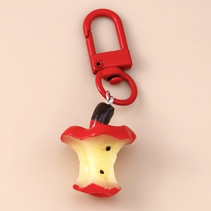 Detailed close-up of a creative apple core keychain with a red lobster clasp and seeds