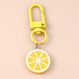 Detail of simulated lemon slice keychain with bright yellow lacquer D-ring and resin texture