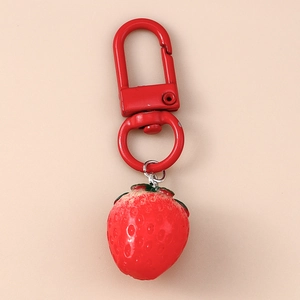 Close-up of realistic strawberry keychain with red lobster clasp and green leaf details