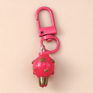Detailed close-up of dragon fruit keychain with pink carabiner and green scale accents