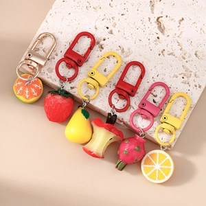 Set of 6 realistic resin fruit keychains with matching colorful lobster clasps on stone