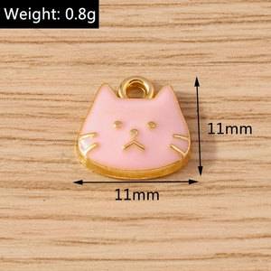 Detailed macro view of a 11mm pink enamel cat charm with a golden alloy finish for DIY crafts