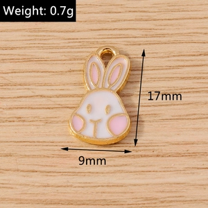 Detail view of 17mm x 9mm enamel bunny charm with weight specs on wood background