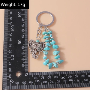 Detailed view of bohemian elephant keychain with turquoise beads and measurement ruler
