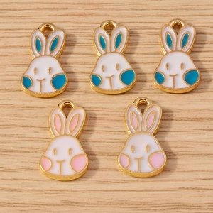 Detail of five colorful enamel rabbit charms with metal loops for DIY jewelry making