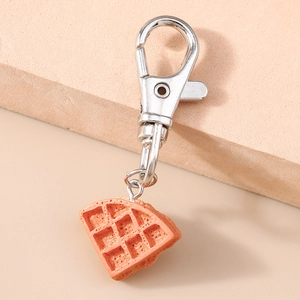 Macro detail of realistic waffle keychain with textured resin finish and silver metal clasp