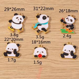 Detail showing various enamel panda pendants with dimensions and weights on wood background