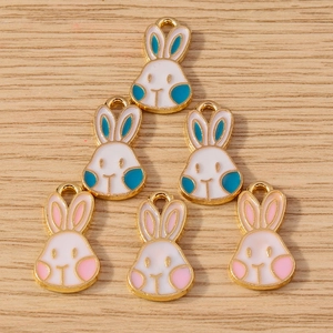 Detail of bunny enamel charms in pink and blue for DIY jewelry making and crafts