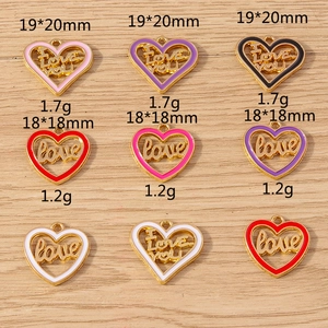 Macro detail of colorful heart charms with love engraving for DIY jewelry making